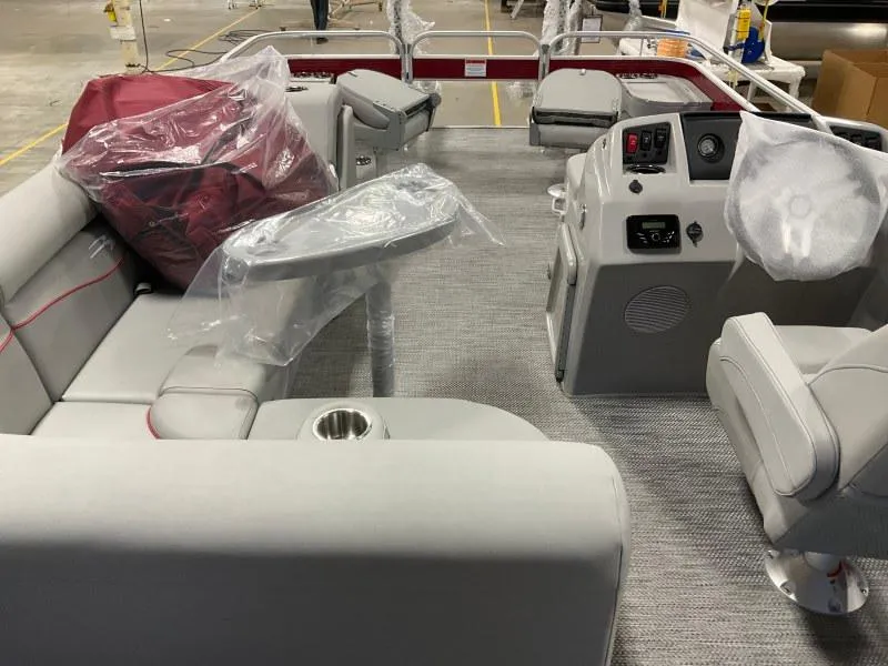 Slide: The Image of 2023 Bennington 20SVF pontoon boat interior with gray seating and control panel. - 12