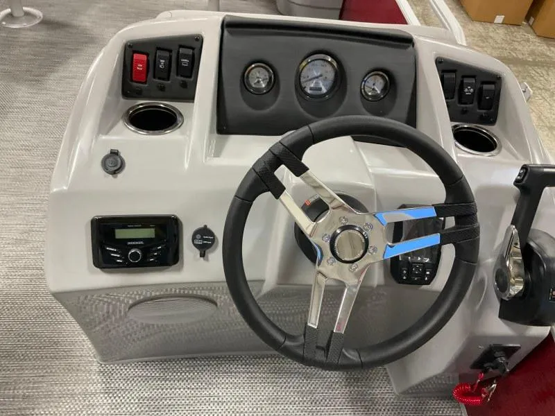Slide: The Image of 2023 Bennington 20SVF boat dashboard with steering wheel and control panel. - 13