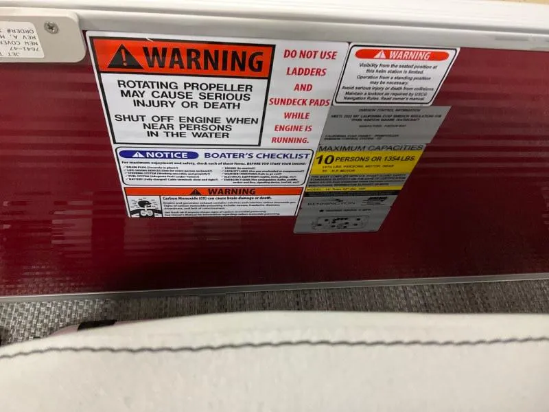 Slide: The Image of Warning labels on 2023 Bennington 20SVF boat, highlighting safety precautions and capacity limits. - 19