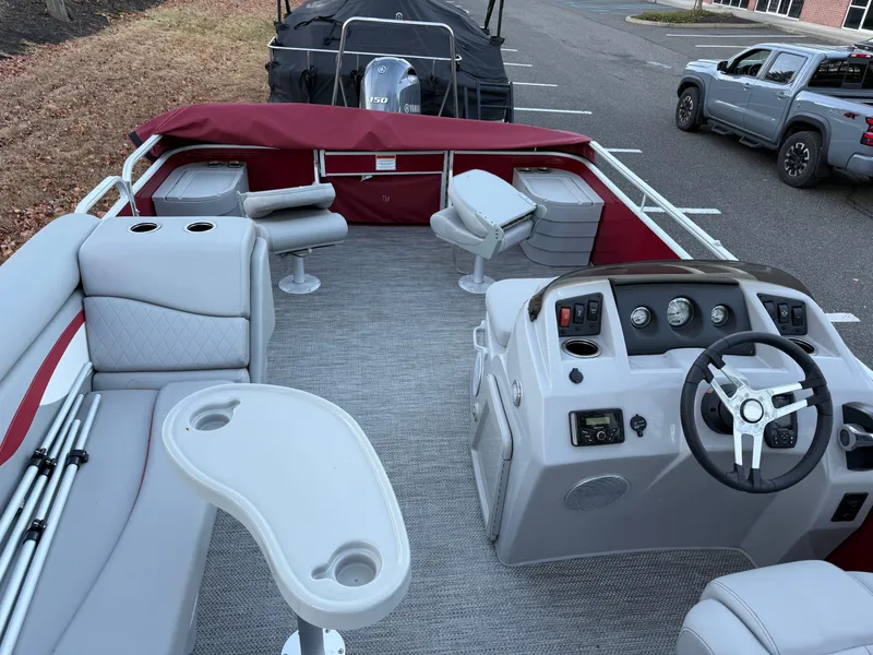 Slide: The Image of 2023 Bennington 20SVF pontoon boat interior with seating, steering console, and table. - 20