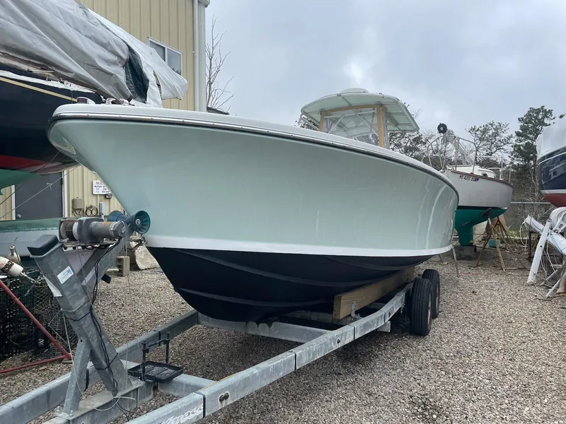 Slide: The Image of 1966 Bertram 25 Moppie boat on trailer, parked outdoors. - 2