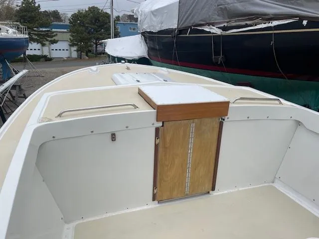 Slide: The Image of 1966 Bertram 25 Moppie boat deck with wooden hatch, docked outdoors. - 5