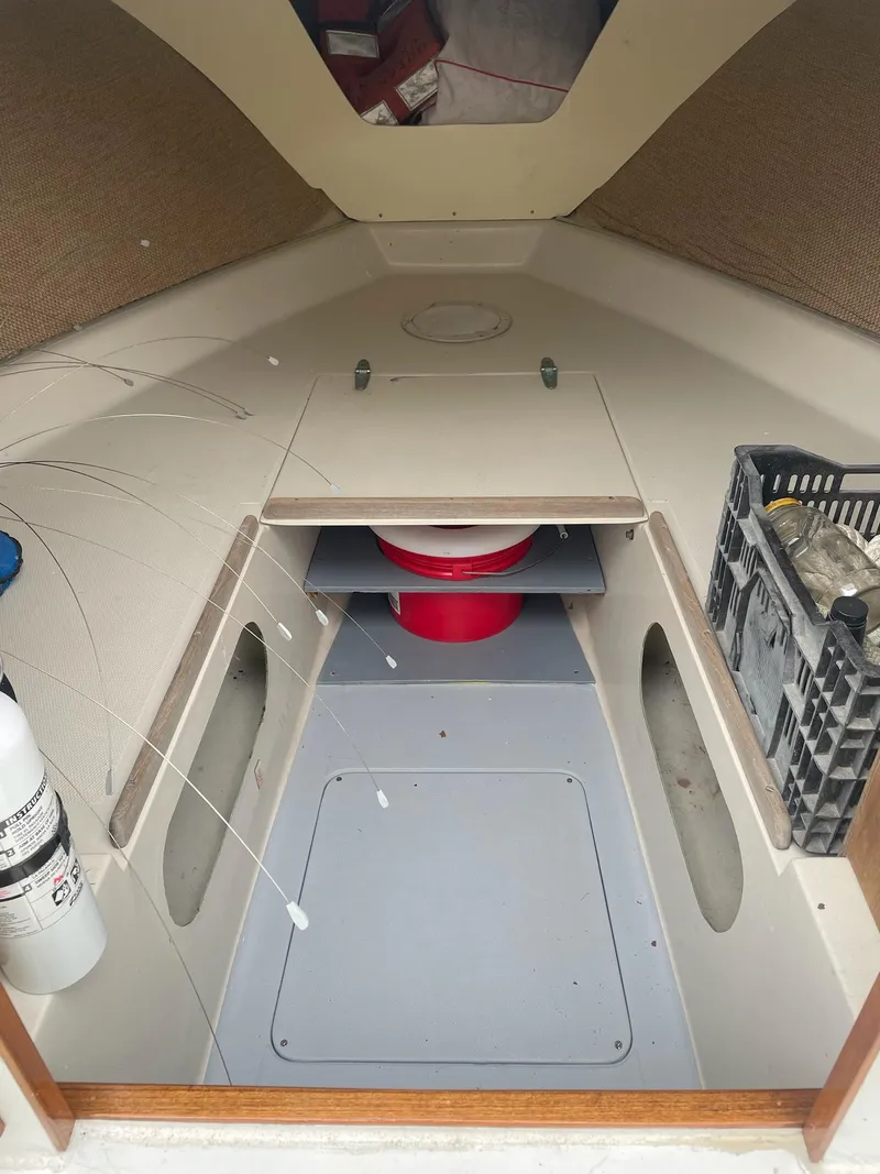 Slide: The Image of Interior of a 1966 Bertram 25 Moppie boat with storage and seating areas. - 6