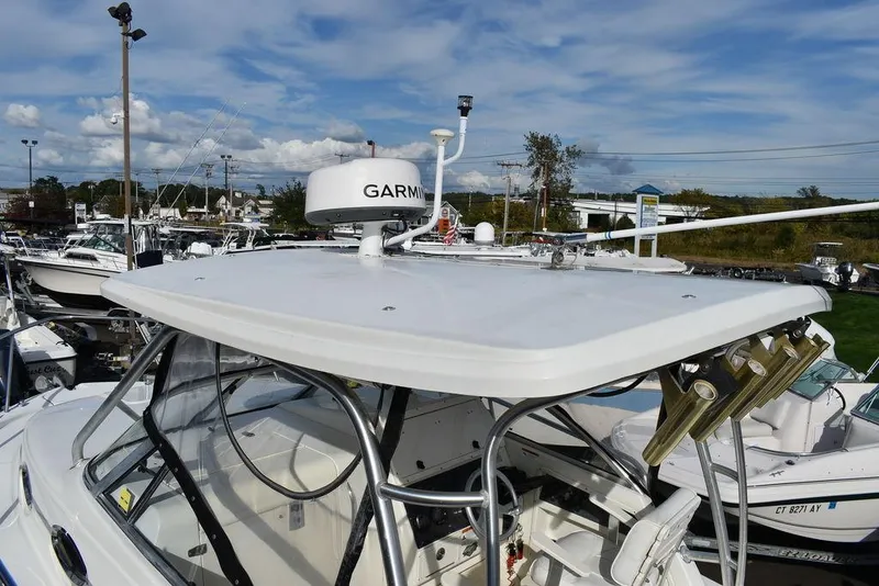 Slide: The Image of 2003 Hydra-Sports 2800 WA Vector boat with Garmin radar, docked under a blue sky. - 15