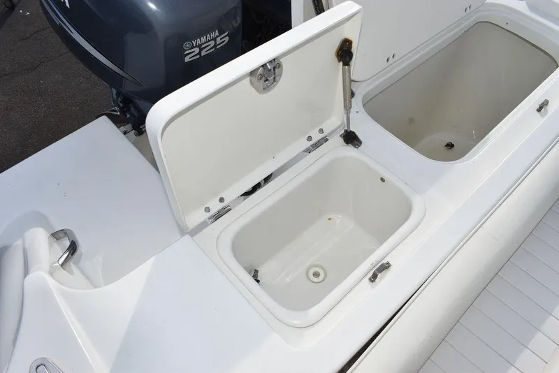 Slide: The Image of 2003 Hydra-Sports 2800 WA Vector boat with open storage compartments and Yamaha 225 engine. - 30