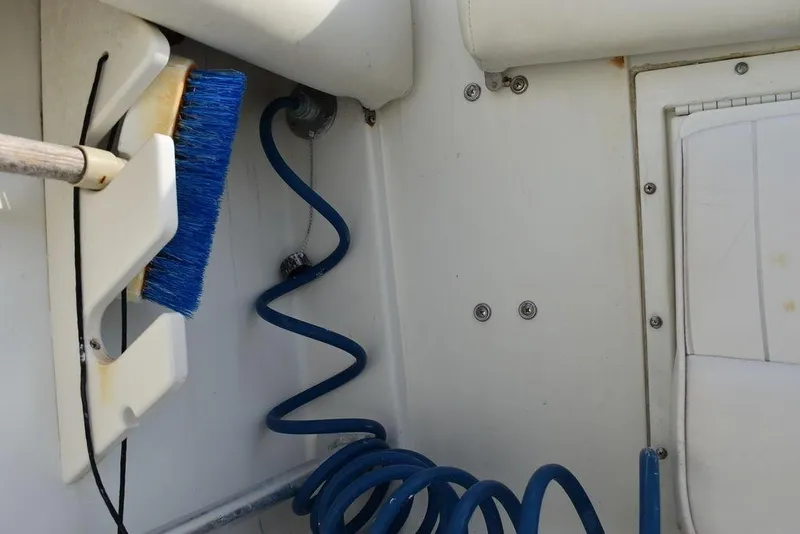 Slide: The Image of 2003 Hydra-Sports 2800 WA Vector boat interior with cleaning brush and coiled hose. - 33