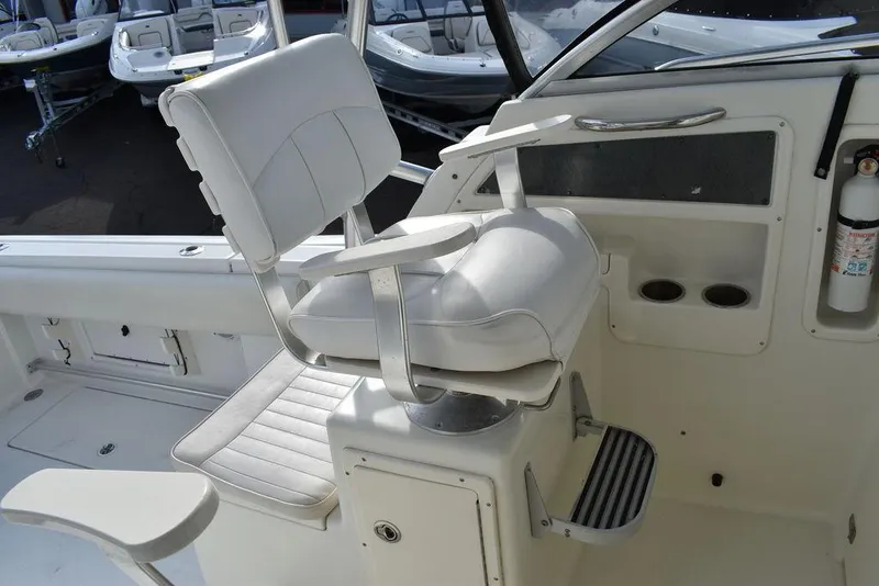 Slide: The Image of 2003 Hydra-Sports 2800 WA Vector boat helm seat with cup holders and fire extinguisher. - 45