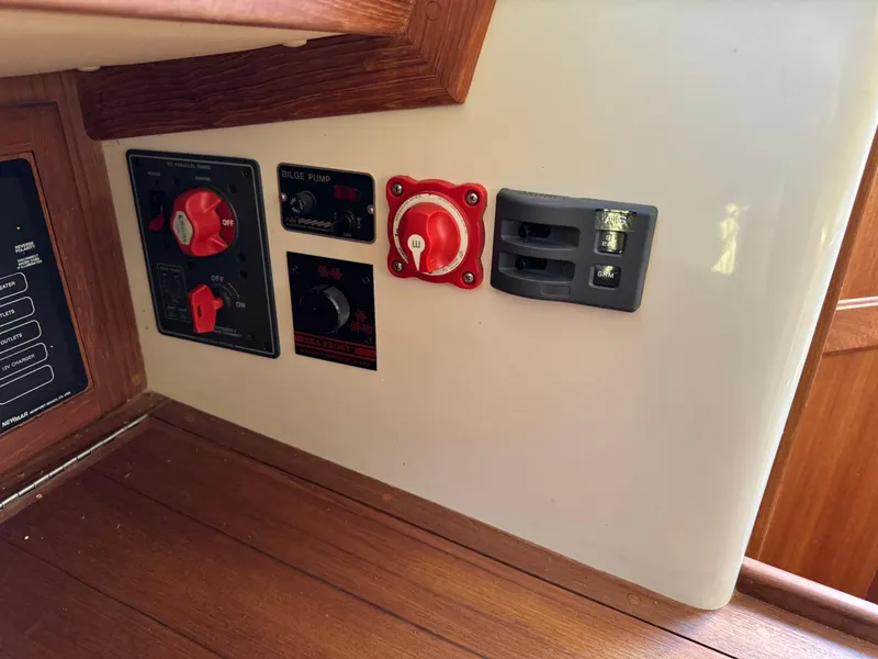 Slide: The Image of Control panel of a 2006 Pacific Seacraft 31 sailboat with switches and gauges. - 12