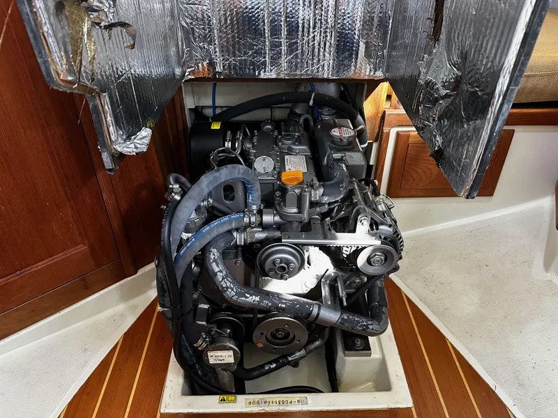 Slide: The Image of Engine compartment of a 2006 Pacific Seacraft 31 sailboat, showcasing mechanical components and insulation. - 17