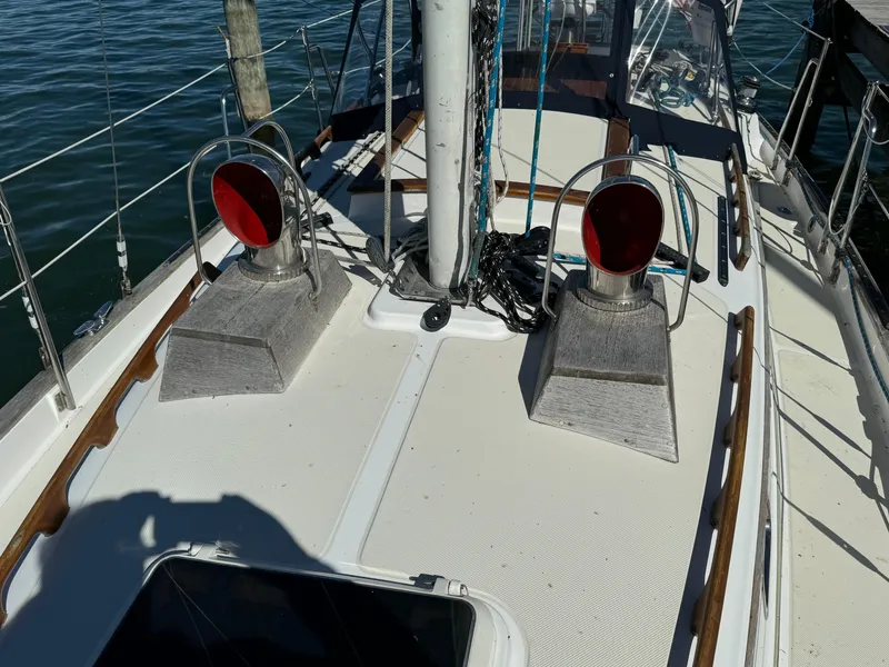 Slide: The Image of 2006 Pacific Seacraft 31 sailboat deck with winches and rigging, docked on calm water. - 4