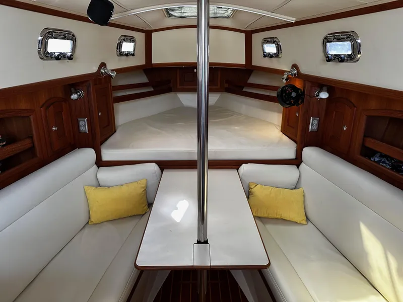 Slide: The Image of Interior of 2006 Pacific Seacraft 31 sailboat with white seating and wooden accents. - 9