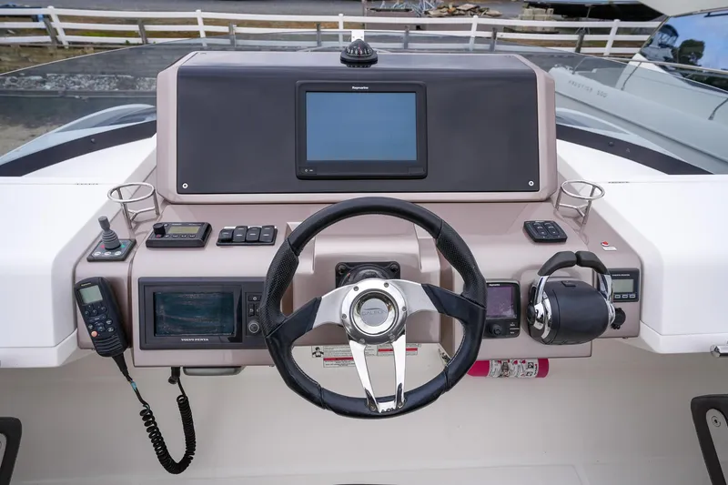 Slide: The Image of Galeon 43 SKY 2017 helm with steering wheel, navigation controls, and display screen. - 14