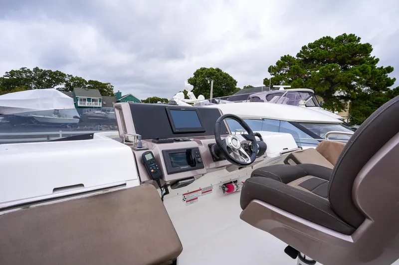Slide: The Image of 2017 Galeon 43 SKY yacht helm with modern controls and comfortable seating. - 16