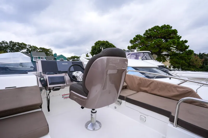 Slide: The Image of 2017 Galeon 43 SKY yacht helm with seating and navigation equipment. - 18
