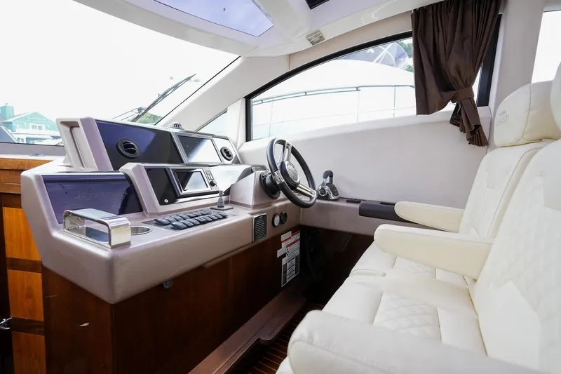 Slide: The Image of Interior of 2017 Galeon 43 SKY yacht cockpit with modern controls and plush seating. - 28