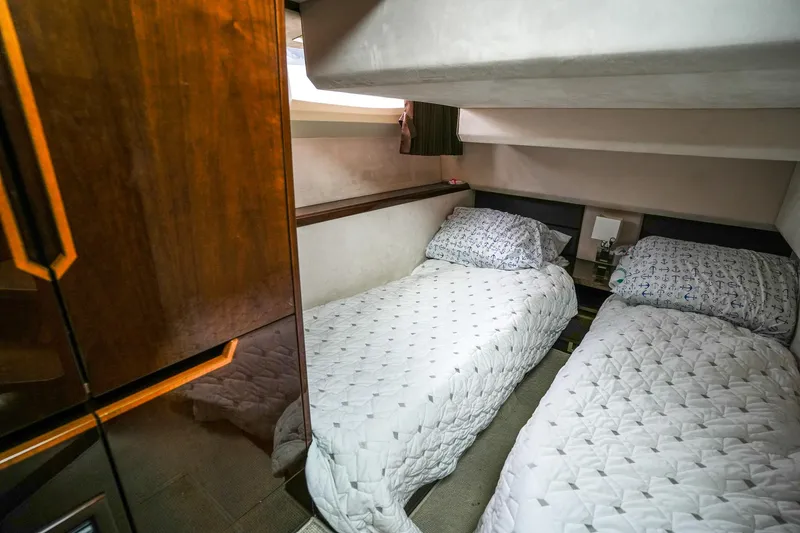 Slide: The Image of Twin beds in 2017 Galeon 43 SKY yacht cabin, featuring elegant wood finishes. - 38