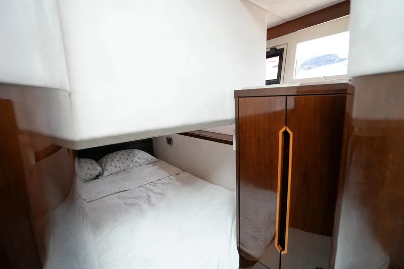 Slide: The Image of Cozy bedroom interior of 2017 Galeon 43 SKY yacht with wooden cabinetry. - 41