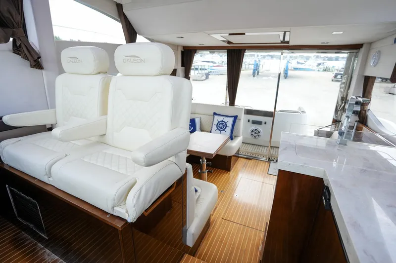 Slide: The Image of Luxurious interior of 2017 Galeon 43 SKY yacht with white leather seating and wooden flooring. - 43