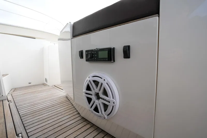 Slide: The Image of Galeon 43 SKY 2017 yacht interior with speaker and control panel on wooden deck. - 45