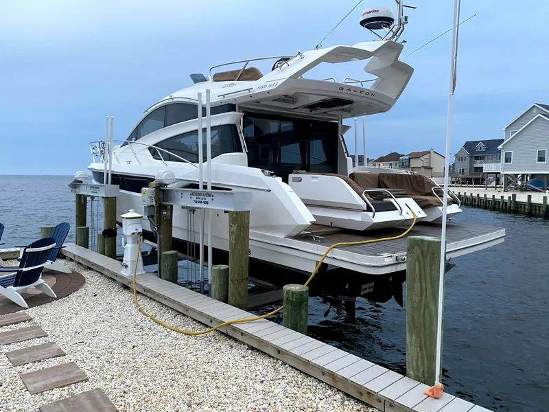 Slide: The Image of 2017 Galeon 43 SKY yacht docked at a marina, featuring sleek design and modern amenities. - 49