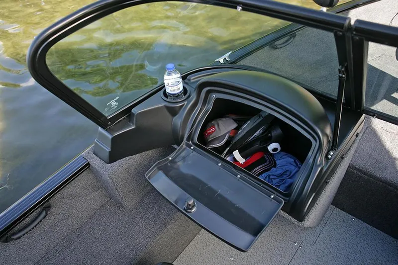 Slide: The Image of 2025 Lund 1650 Rebel XL Sport boat interior with Mercury engine, gray carpet, and seating. - 10