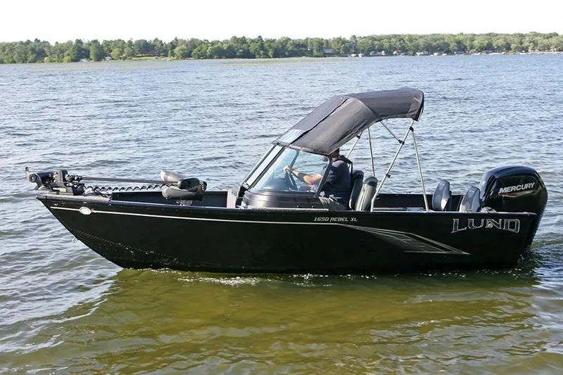 Slide: The Image of 2025 Lund 1650 Rebel XL Sport boat interior with four cushioned seats. - 4