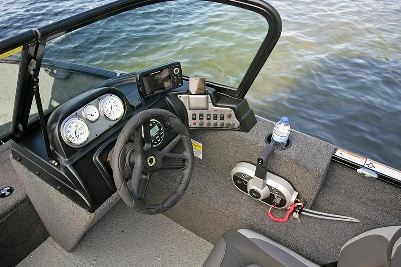 Slide: The Image of 2025 Lund 1650 Rebel XL Sport boat interior with gray carpet and blue trim. - 9