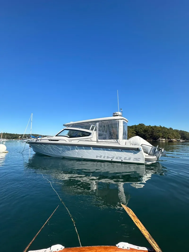 The Image of Nimbus W9 2021 boat on calm water under clear blue sky. - 0