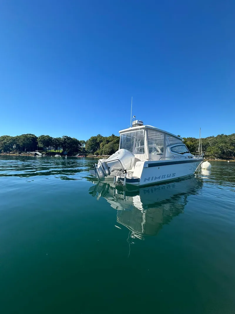 Slide: The Image of Nimbus W9 2021 boat on calm water under clear blue sky. - 10