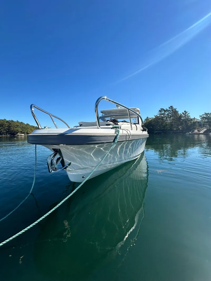 Slide: The Image of 2021 Nimbus W9 boat on calm water under clear blue sky. - 11