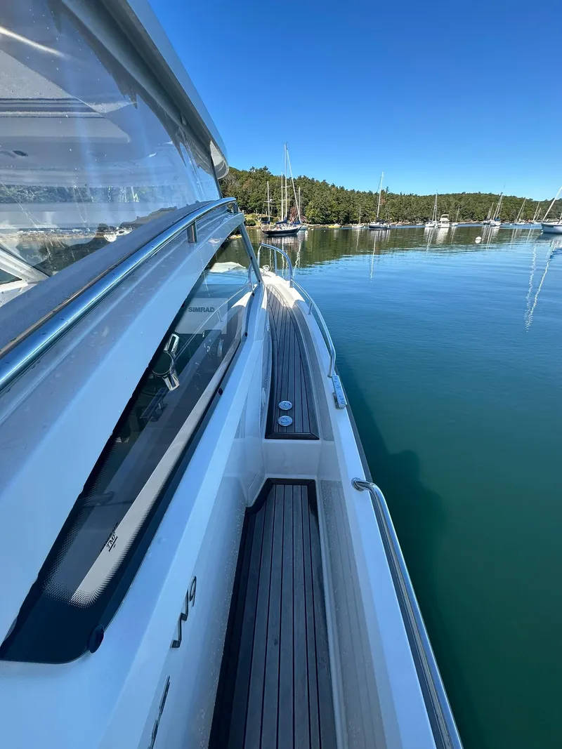 Slide: The Image of Nimbus W9 2021 boat on calm water with clear blue sky. - 14