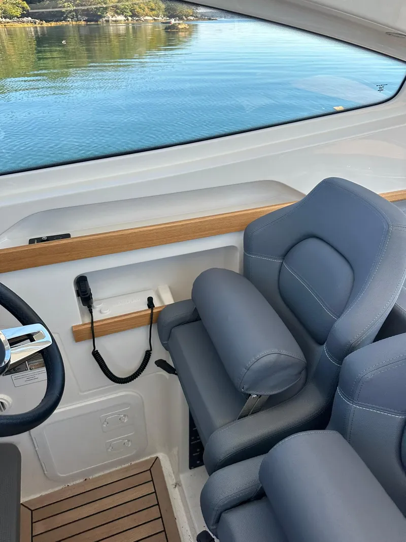 Slide: The Image of Interior of 2021 Nimbus W9 boat with blue seats and scenic water view. - 20