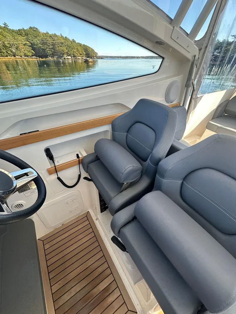 Slide: The Image of 2021 Nimbus W9 boat interior with plush seating and scenic water view. - 21