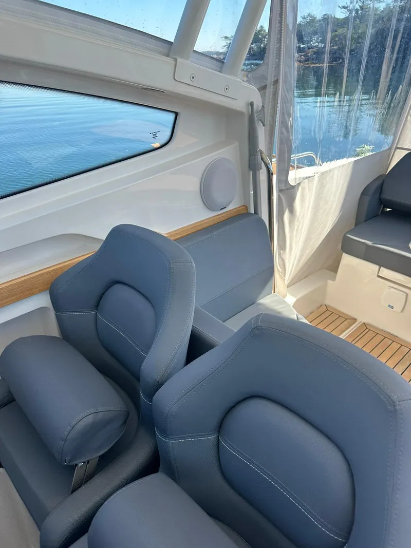 Slide: The Image of Interior of 2021 Nimbus W9 boat with blue seating and wooden flooring. - 25