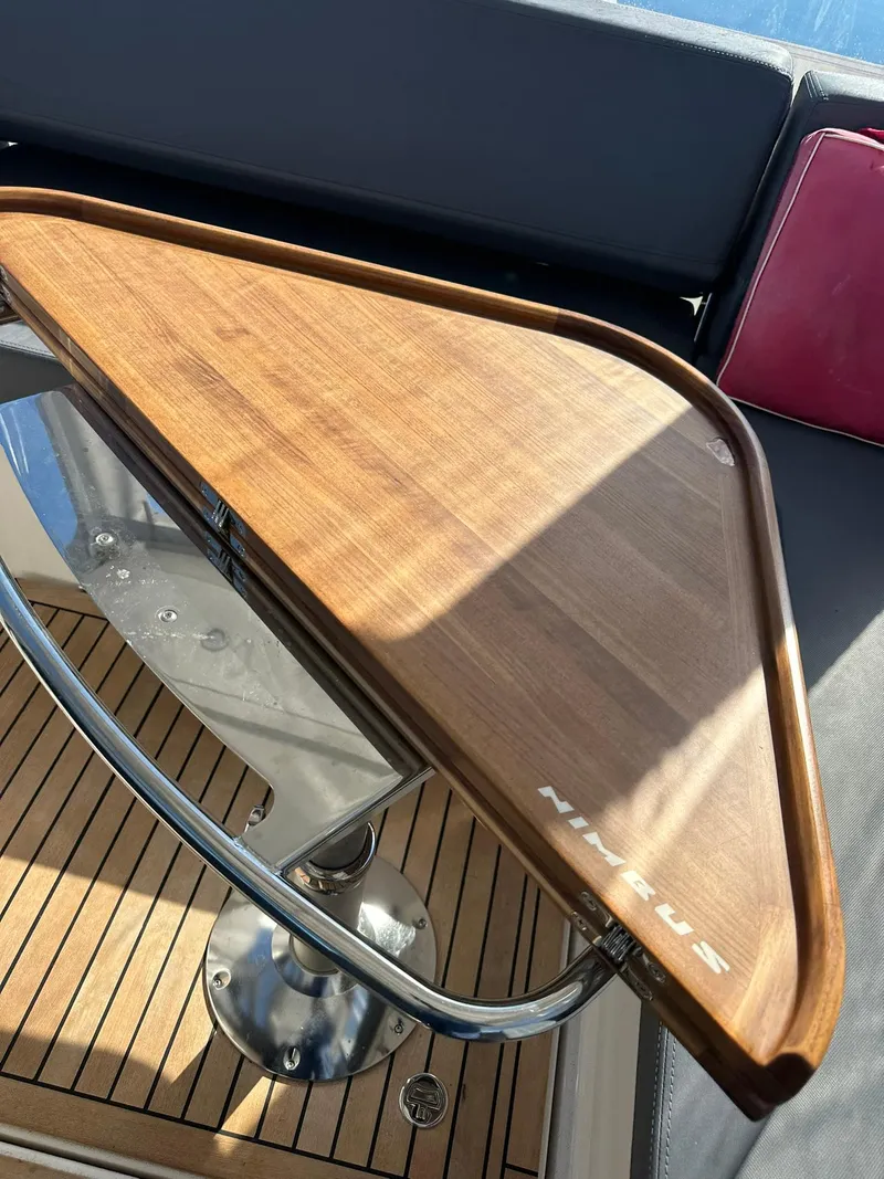 Slide: The Image of Wooden table on Nimbus W9 boat, 2021 model, with sleek metal support. - 28
