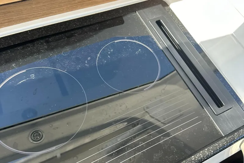Slide: The Image of Modern glass cooktop on 2021 Nimbus W9 boat kitchen. - 32