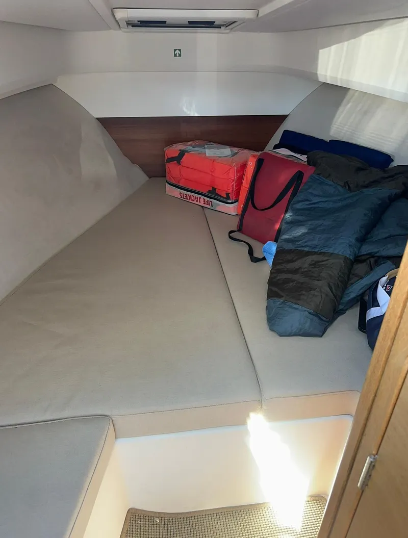 Slide: The Image of Cozy cabin interior of 2021 Nimbus W9 boat with cushions and bags. - 33