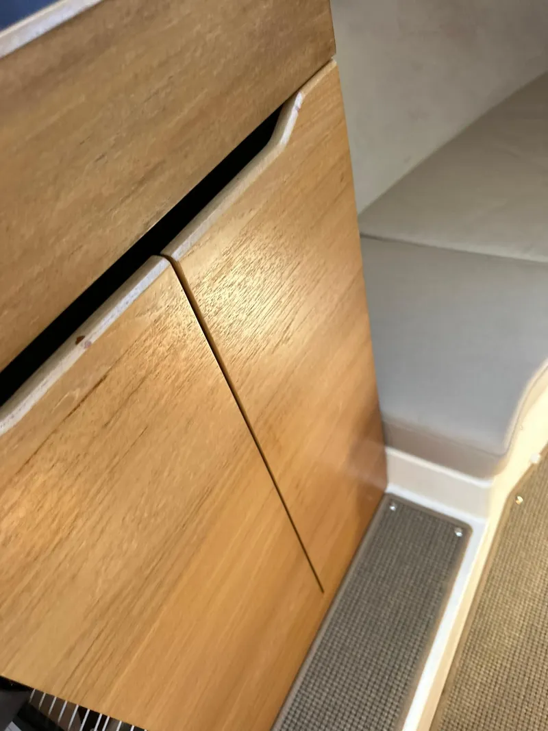 Slide: The Image of Interior of 2021 Nimbus W9 boat with wooden cabinetry and cushioned seating. - 34