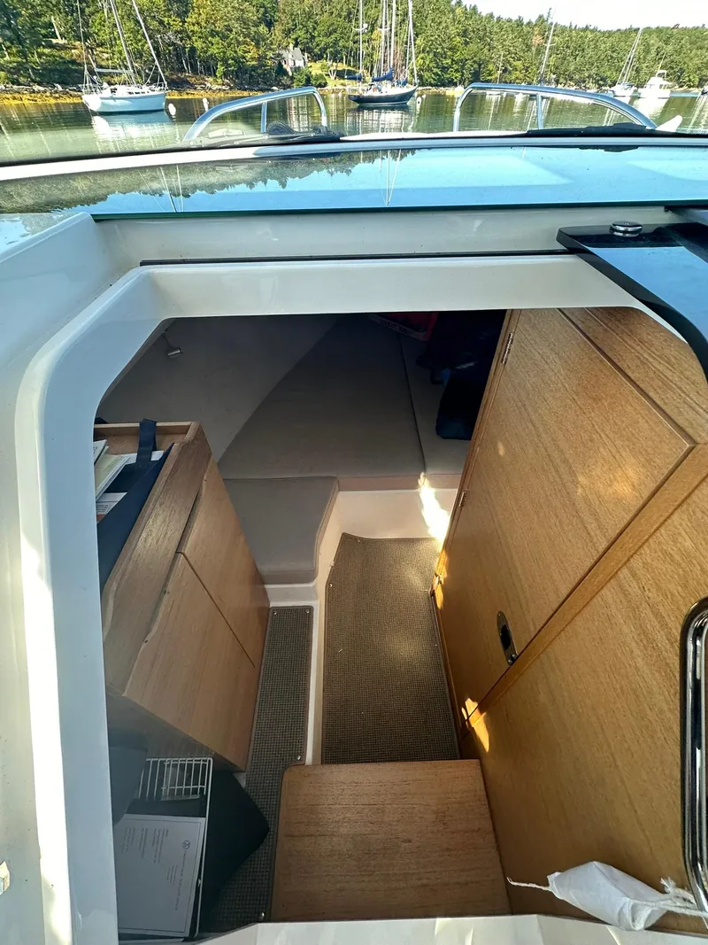 Slide: The Image of Interior view of 2021 Nimbus W9 boat cabin with wooden furnishings. - 44