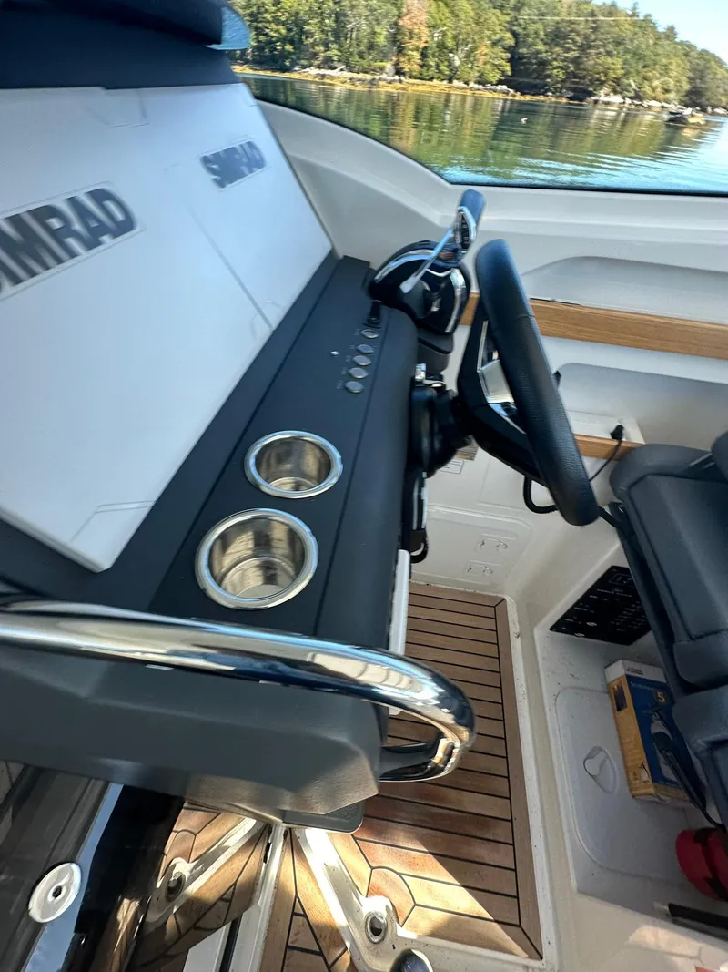 Slide: The Image of 2021 Nimbus W9 boat cockpit with steering wheel and control panel. - 45