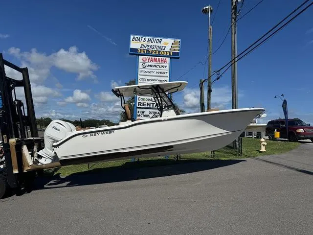 The Image of 2025 Key West 263 FS boat displayed at dealership under clear blue sky. - 1