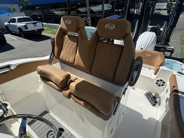 Slide: The Image of 2025 Key West 263 FS boat with tan leather seats and steering wheel. - 11
