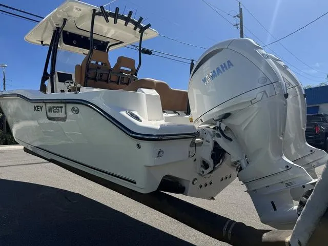Slide: The Image of 2025 Key West 263 FS boat with Yamaha engine, docked under clear blue sky. - 4