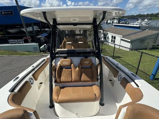 Slide: The Image of 2025 Key West 263 FS boat with tan seating and spacious deck. - 9