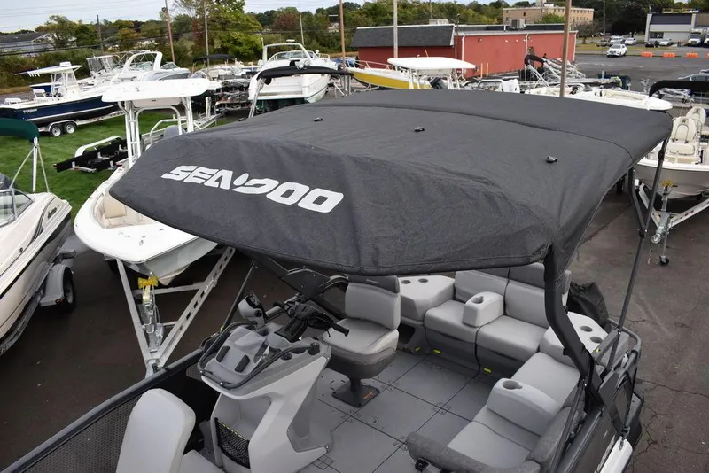 Slide: The Image of 2023 Sea-Doo Switch Cruise 18-230 hp pontoon boat with canopy in marina. - 14