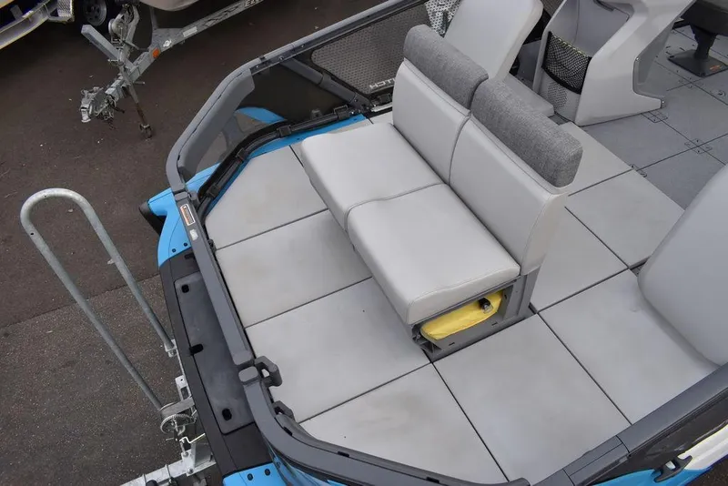 Slide: The Image of 2023 Sea-Doo Switch® Cruise 18-230 hp boat interior with gray seating and spacious deck. - 15