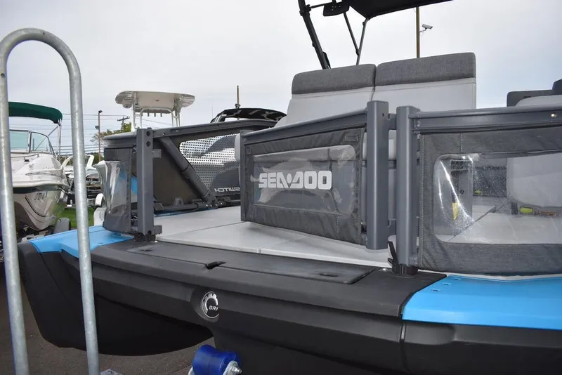 Slide: The Image of 2023 Sea-Doo Switch Cruise 18-230 hp pontoon boat, rear view, docked. - 18
