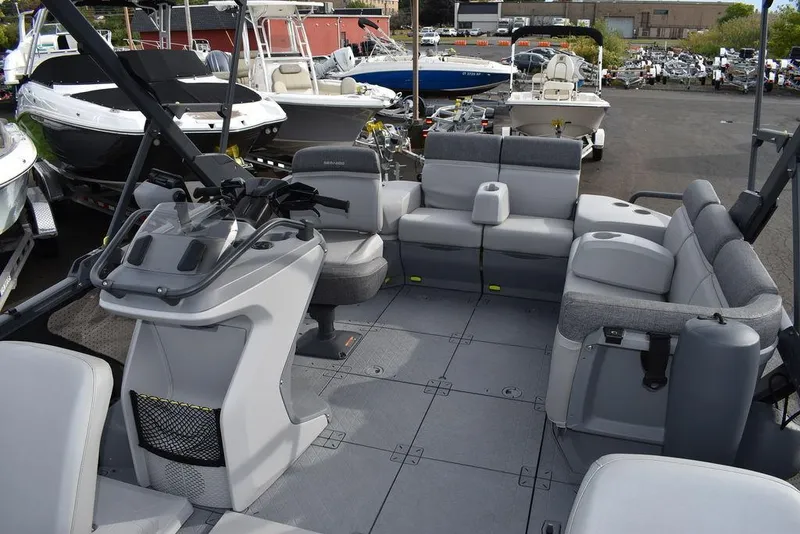 Slide: The Image of 2023 Sea-Doo Switch® Cruise 18-230 hp pontoon boat interior with spacious seating and helm. - 21