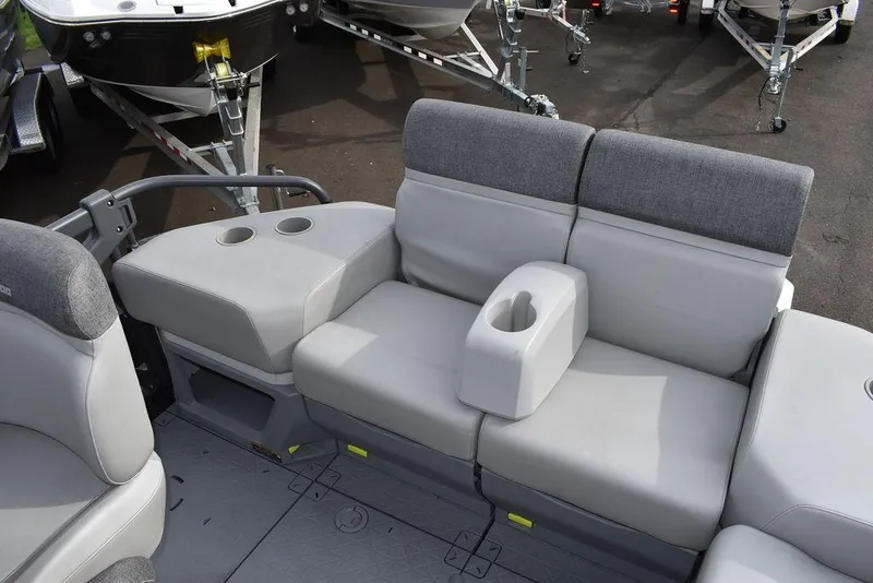Slide: The Image of 2023 Sea-Doo Switch Cruise 18-230 hp boat seating with cup holders and gray upholstery. - 23
