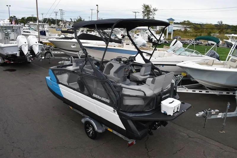 Slide: The Image of 2023 Sea-Doo Switch Cruise 18-230 hp pontoon boat on trailer in marina setting. - 3